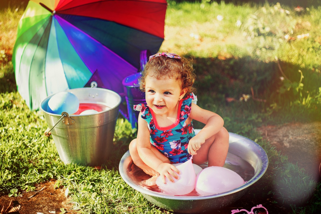 Girl Playing with Balloons Outside