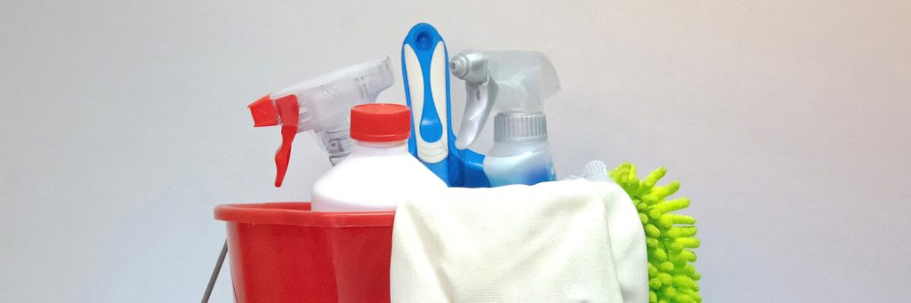 red bucket with cleaning supplies inside