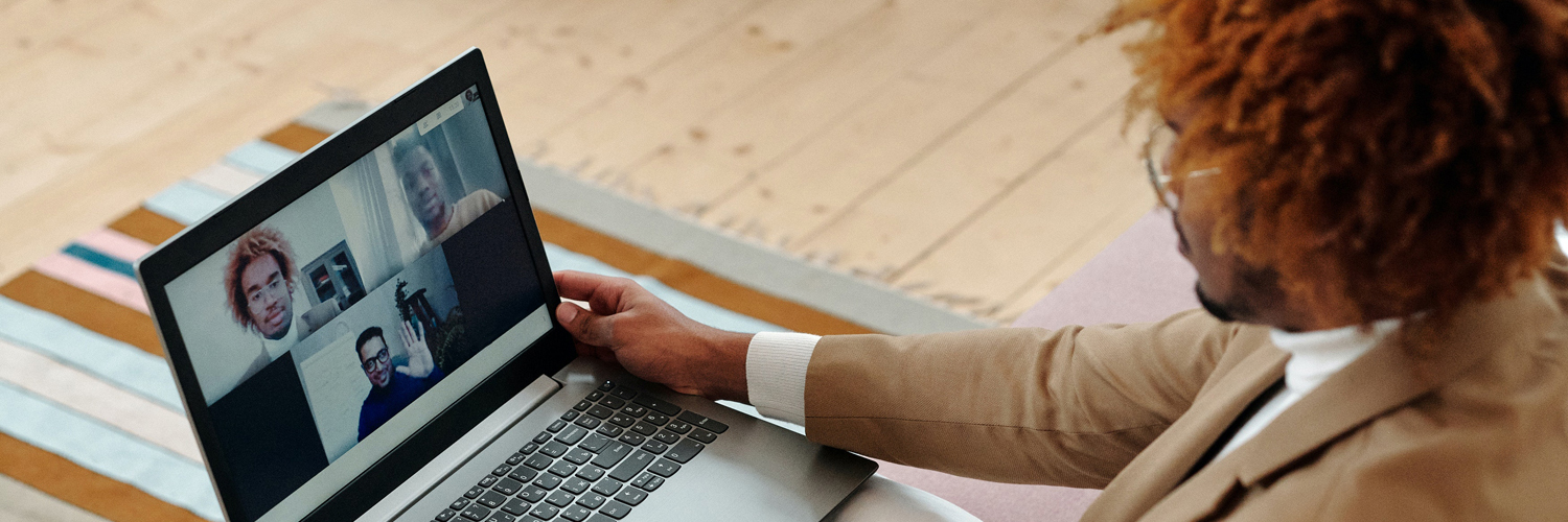 new hire using his laptop to complete the remote onboarding process for a new job