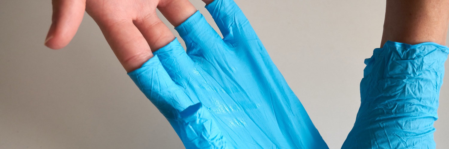 someone taking off blue disposable gloves