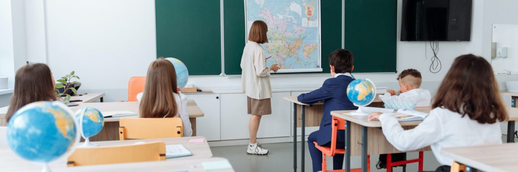 students sitting in rows listening to the geography lesson