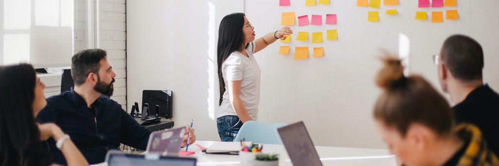 brainstorming on whiteboard with sticky notes