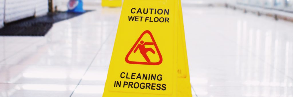 yellow caution wet floor sign in store