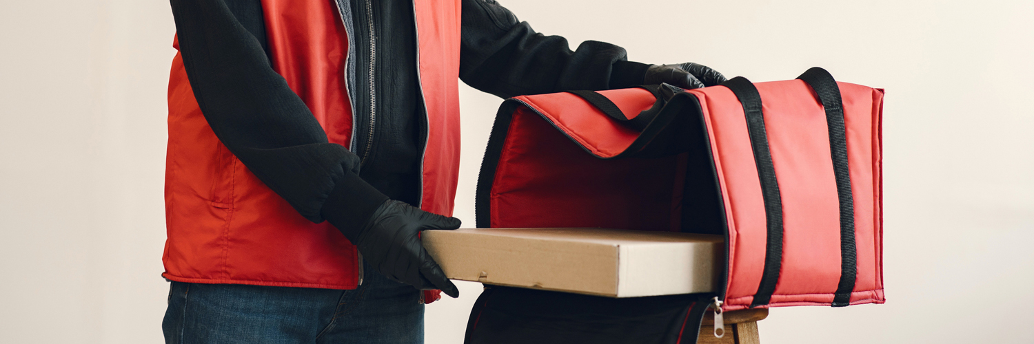 Man with insulated bag delivering a pizza