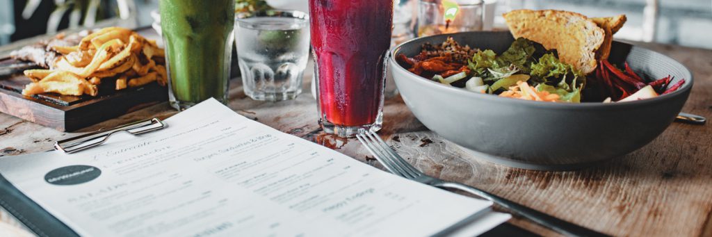 food and drinks on table with menu