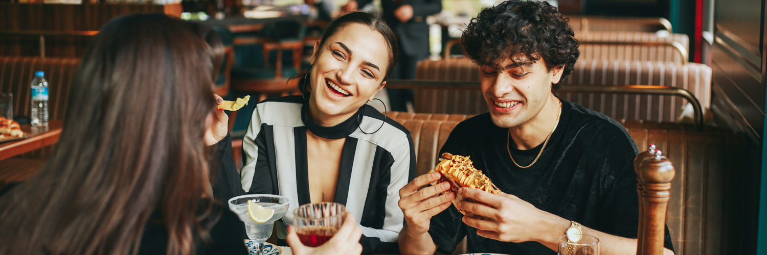 three people eating at restaurant