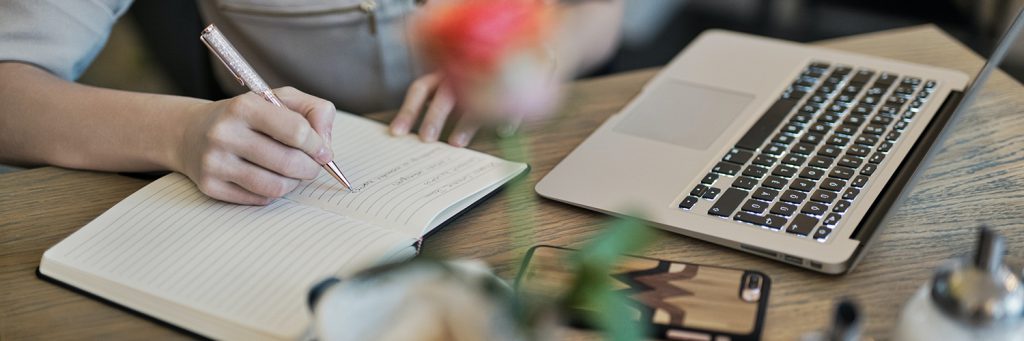 woman writing tasks in journal