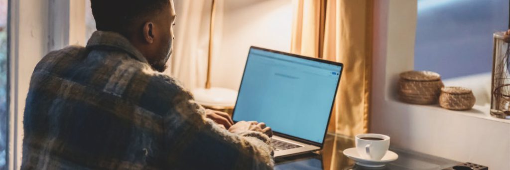 Man working at desk with coffee
