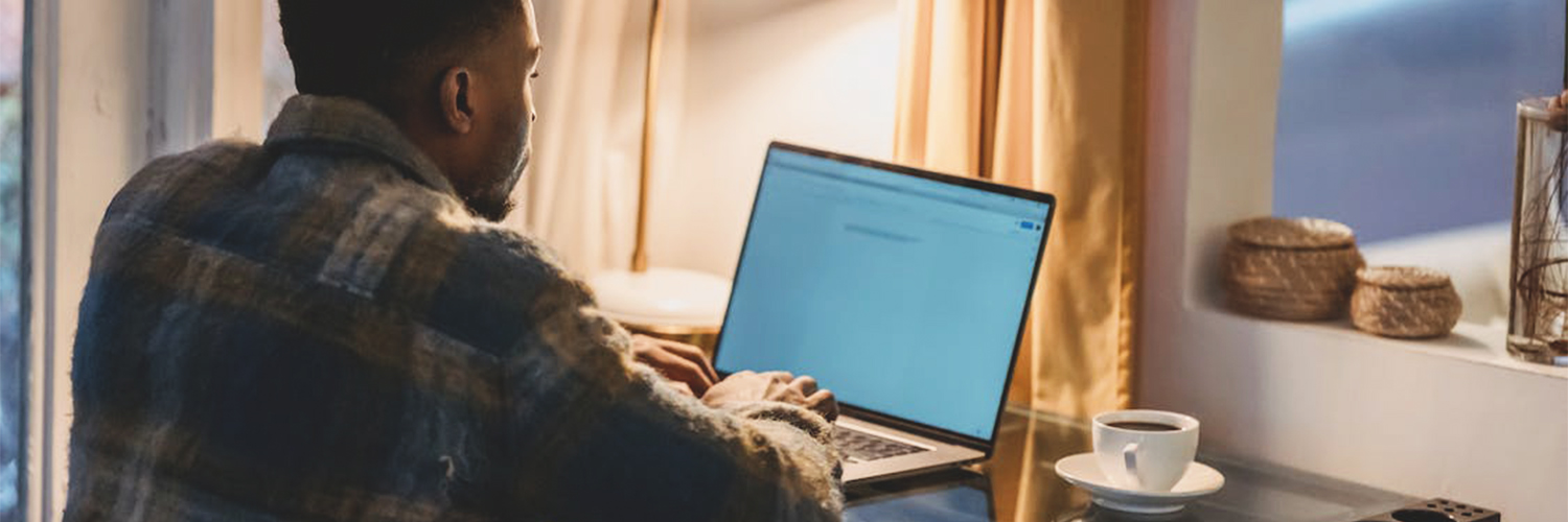 Man working at desk with coffee