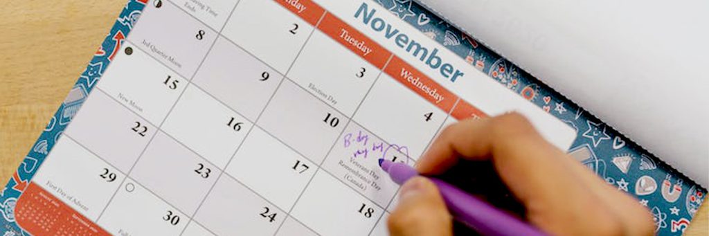 someone-writing-on-calendar