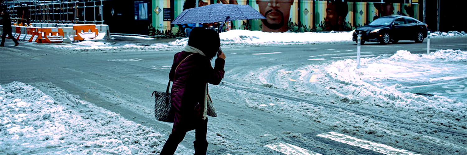 woman walking in snow on street