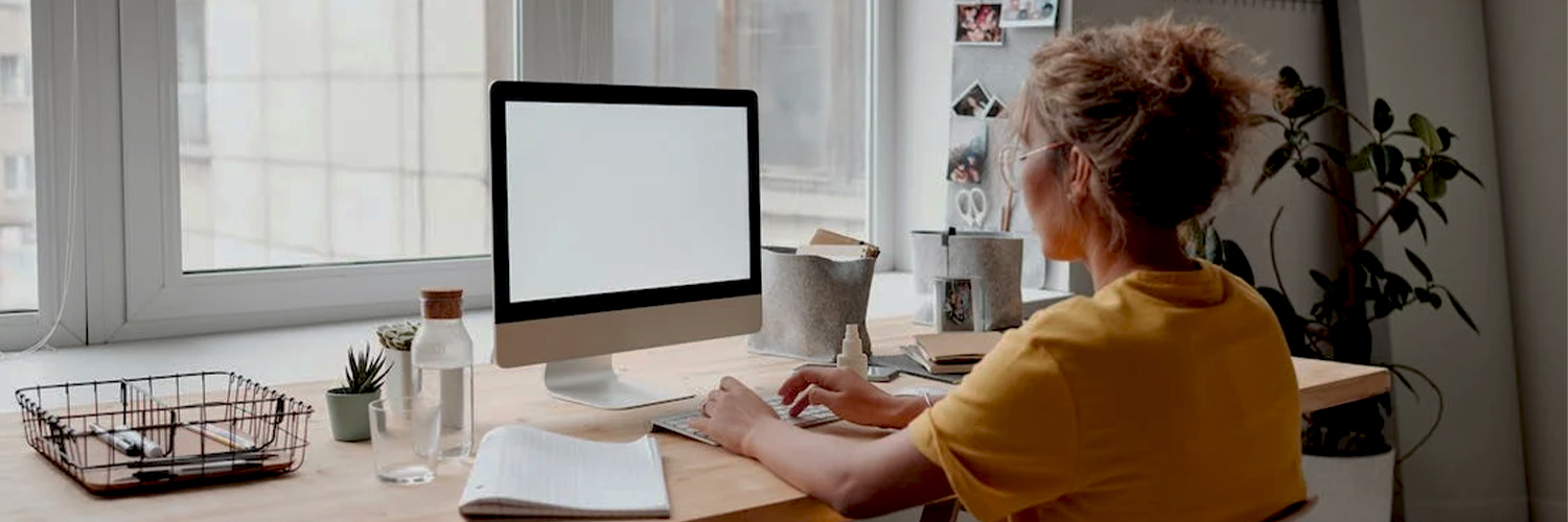 Woman in yellow shirt working from home