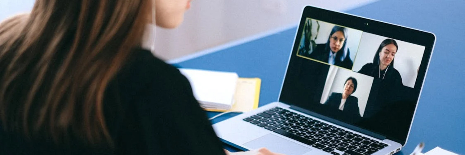 Woman meeting with team members online