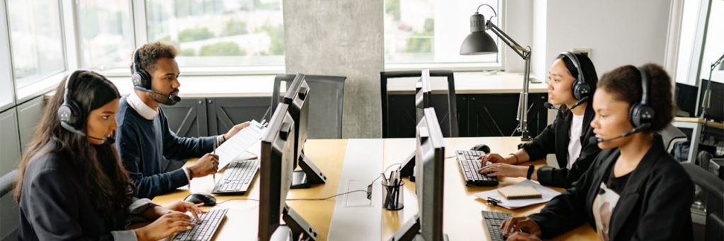 Employees with headsets on working