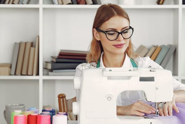 woman sewing fabric at desk
