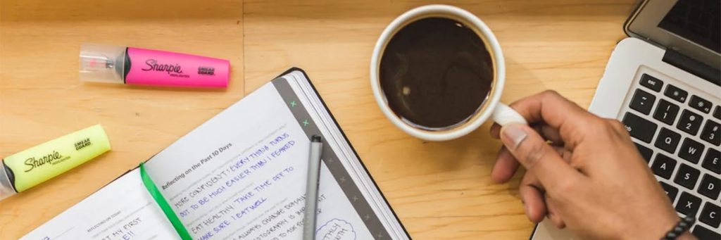 holding coffee while working