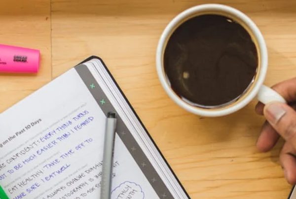 holding coffee while working