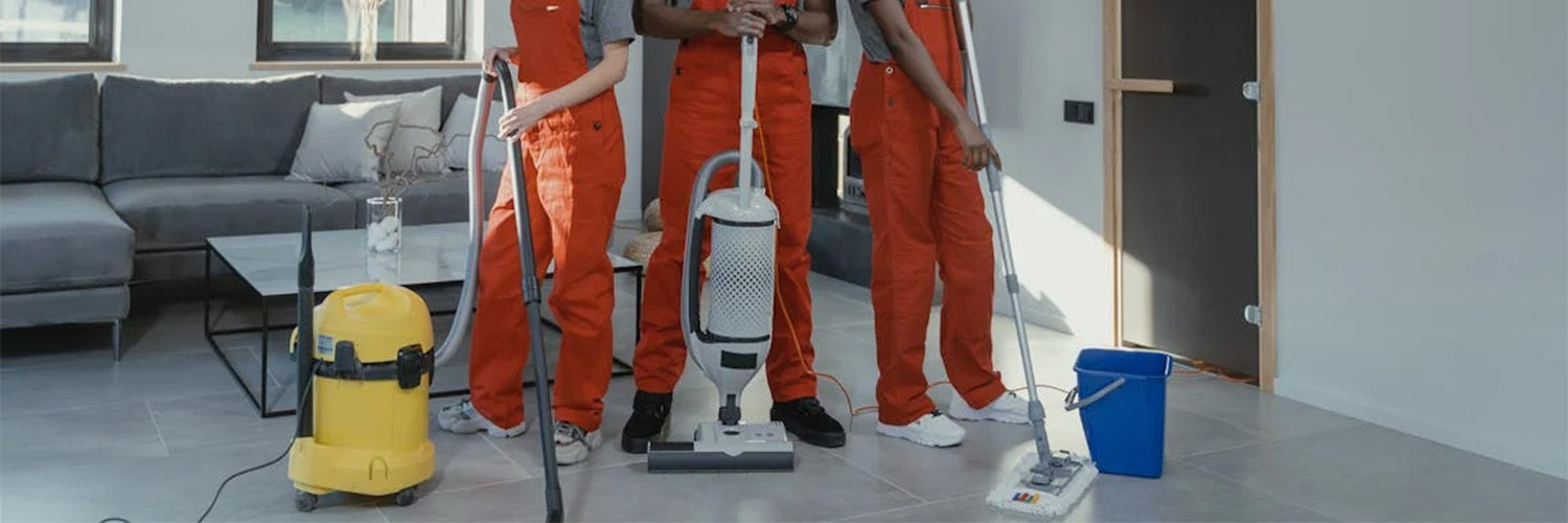 three people with floor cleaning tools