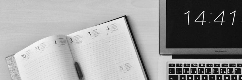 planner next to laptop