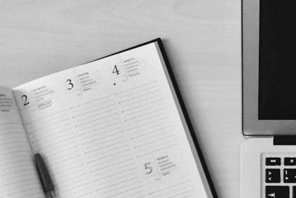 planner next to laptop