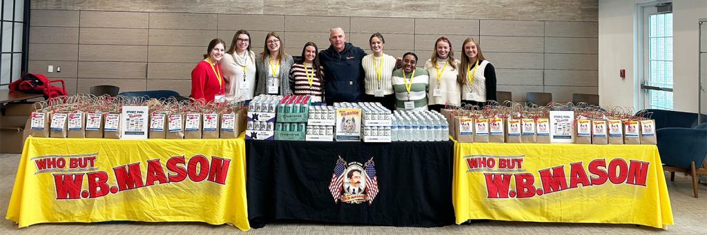 people gathered around table with goody bags