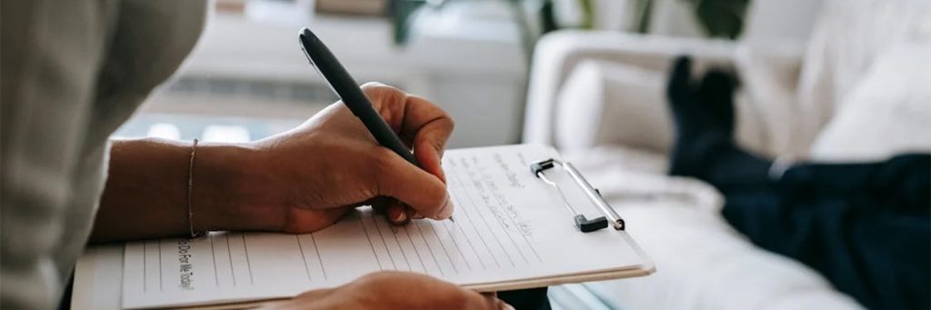 person writing with pen