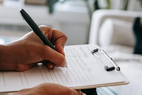 person writing with pen