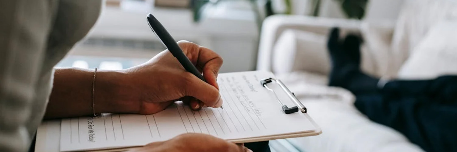 person writing with pen